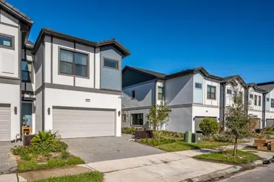 a group of houses with a driveway at Modernparadiso Grande5Bedspool in Orlando