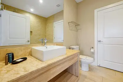 a bathroom with a sink and a toilet at Magic Village Resort 5 Minutes to Disney!! in Orlando