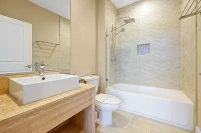 a bathroom with a sink and a tub and a toilet at Magic Village Resort 5 Minutes to Disney!! in Orlando