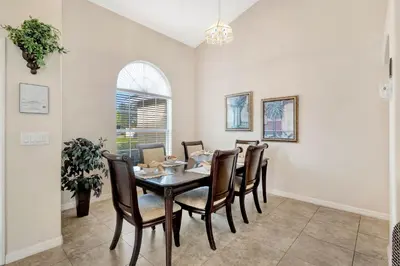 a dining room with a table and chairs at Anthea's Disney Vacation Home in Orlando
