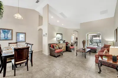a living room filled with furniture and a table at Anthea's Disney Vacation Home in Orlando