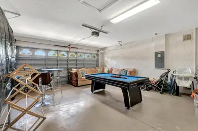a living room with a ping pong table in it at Anthea's Disney Vacation Home in Orlando