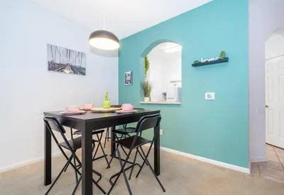 a dining room with a black table and chairs at Beautiful Resort 3 Bedrooms Condo Near Disney in Kissimmee