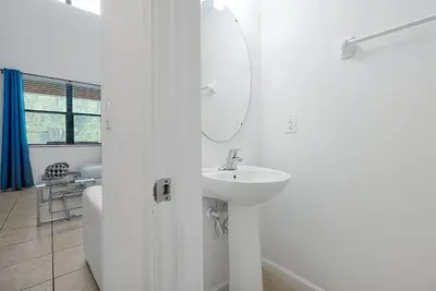 a white bathroom with a sink and a mirror at Disney Dream at Veranda Palms Resort in Kissimmee