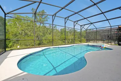 a large swimming pool in a building with a roof at Disney Dream at Veranda Palms Resort in Kissimmee