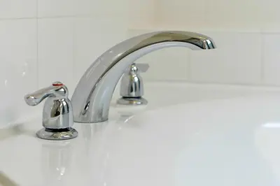 a bathroom sink with two faucets on it at Disney Dream at Veranda Palms Resort in Kissimmee