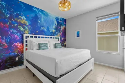 a bedroom with a large fish mural on the wall at *Sun Palm Paradise* | Sleeps 14 | Near Disney! in Kissimmee