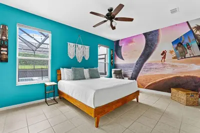 a bedroom with a bed with a blue wall at *Sun Palm Paradise* | Sleeps 14 | Near Disney! in Kissimmee