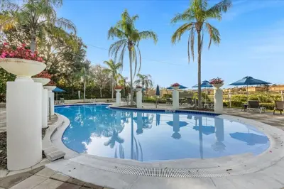 a pool at a resort with palm trees at 3 Bedrooms 2 Bathrooms Encantada 3070 Wo in Kissimmee