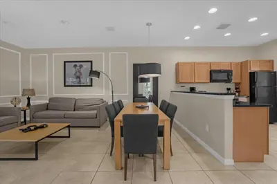 a living room with a table and a couch and a kitchen at 3 Bedrooms 2 Bathrooms Encantada 3070 Wo in Kissimmee
