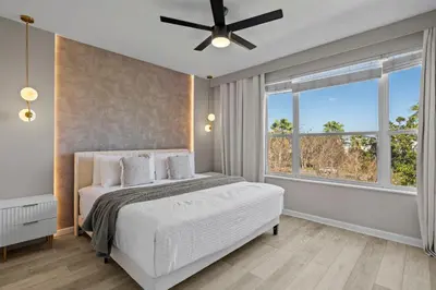 a bedroom with a bed and a ceiling fan at 3 Bedrooms 35 Bathrooms Vista Cay 4845-148 in Orlando