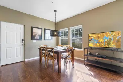a dining room with a table and chairs and a tv at Outstanding 4 bdr near Disney 16108 in Kissimmee
