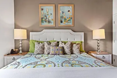 a bedroom with a large bed with two lamps at New 4BDR House near Disney 8979 in Kissimmee