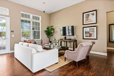 a living room with a white couch and chairs at New 4BDR House near Disney 8979 in Kissimmee