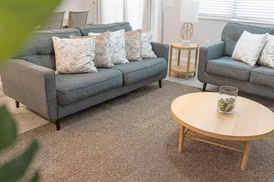 a living room with two couches and a coffee table at Family House near Disney - 5109 in Kissimmee
