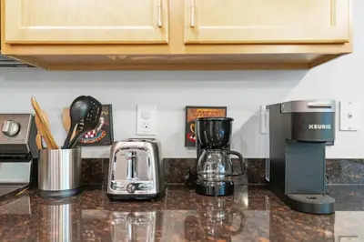 a kitchen counter with a coffee maker and affeepot at Family House near Disney - 5109 in Kissimmee