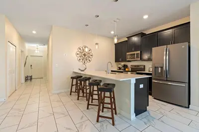 a kitchen with a large island with bar stools at Amazing 5Bdr House with pool 4857 in Kissimmee