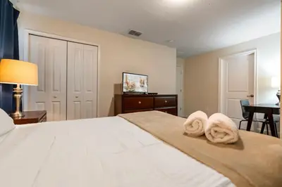 a bedroom with a bed with towels on it at Amazing 5Bdr House with pool 4857 in Kissimmee