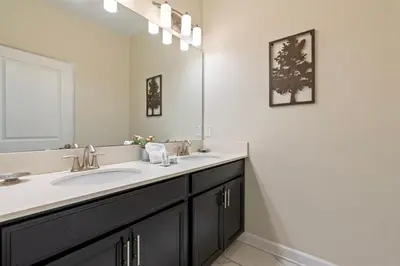 a bathroom with a sink and a mirror at Amazing 5Bdr House with pool 4857 in Kissimmee