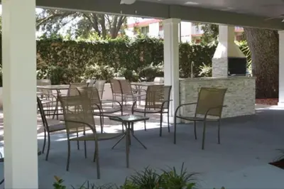 a group of chairs and tables on a patio at Luxury 4BDR House close to Parks in Kissimmee