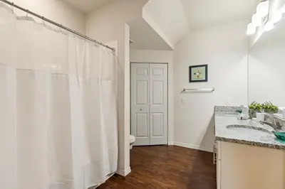 a bathroom with a white shower curtain and a toilet at 3BR Disney Escape for Families in Kissimmee