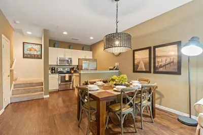 a kitchen and dining room with a table and chairs at 3BR Disney Escape for Families in Kissimmee