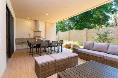 a patio with a couch and a table and chairs at Luxury 3BDR House near Disney 7527 in Orlando