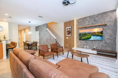 a living room with a couch and a table at Paradise renovated 5 BD walk to clubhouse 8935 in Kissimmee