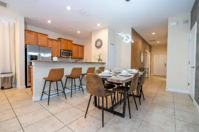 a kitchen and dining room with a table and chairs at Paradise renovated 5 BD walk to clubhouse 8935 in Kissimmee