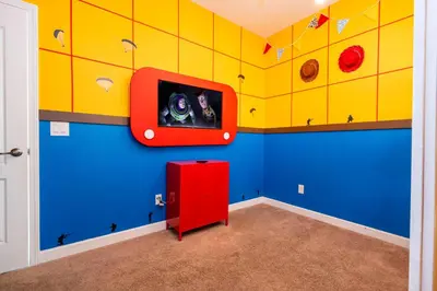 a room with a tv on a wall at Paradise renovated 5 BD walk to clubhouse 8935 in Kissimmee
