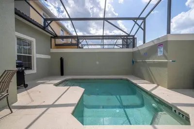 a swimming pool in a house with a glass ceiling at Paradise renovated 5 BD walk to clubhouse 8935 in Kissimmee