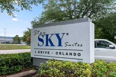 a sign for a sign for a skiasy surfer istg at Hotel Room Next to Universal At Stay Sky Suites in Orlando