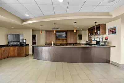 a large lobby with a bar in a hotel at Hotel Room Next to Universal At Stay Sky Suites in Orlando