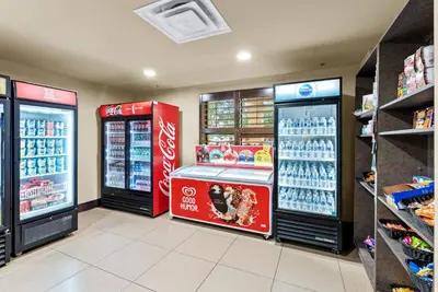 a store with two soda machines in a store at Hotel Room Next to Universal At Stay Sky Suites in Orlando