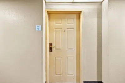 a white door in a hallway in a room at Hotel Room Next to Universal At Stay Sky Suites in Orlando