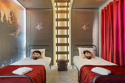 two beds in a room with red curtains at Family 5BR Retreat w Pool Near Disney in Kissimmee