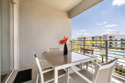 a dining room with a table and chairs on a balcony at 3 Bedrooms 2 Bathrooms Storey Lake 3180-308 in Kissimmee