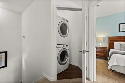 a bathroom with a washing machine in a room at 4 Bedrooms 3 Bathrooms Lucaya Village 19-104 in Kissimmee