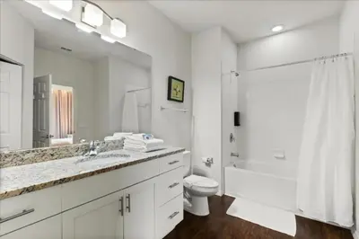 a white bathroom with a sink and a toilet at 4 Bedrooms 3 Bathrooms Lucaya Village 19-104 in Kissimmee