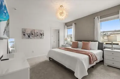 a white bedroom with a bed and a window at 15 Bedrooms155 Bathroomsveranda Palms 2477Rd in Kissimmee