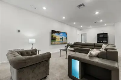 a living room with two couches and a tv at 15 Bedrooms155 Bathroomsveranda Palms 2477Rd in Kissimmee