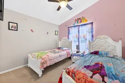 a bedroom with two beds and a ceiling fan at Entire Disney Retreat Home minutes from Disney, Shopping, and Restaurants 4br,2ba,7beds sleeps 10 in Orlando