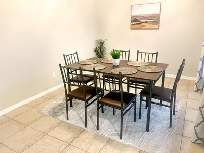 a dining room with a table and chairs at Entire Disney Retreat Home minutes from Disney, Shopping, and Restaurants 4br,2ba,7beds sleeps 10 in Orlando