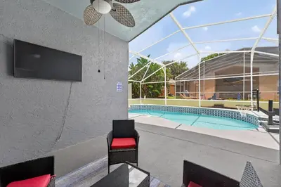 a view of a swimming pool in a house at Entire Disney Retreat Home minutes from Disney, Shopping, and Restaurants 4br,2ba,7beds sleeps 10 in Orlando