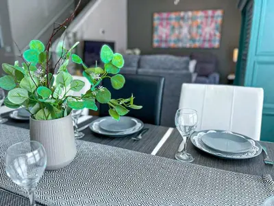 a table with plates and a vase with a plant on it at Perfect vacation spot near Disney 7105 in Kissimmee