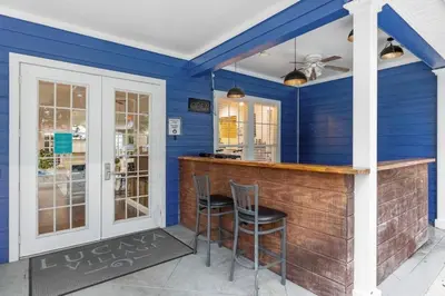 a blue room with a bar with two stools at Perfect vacation spot near Disney 7105 in Kissimmee