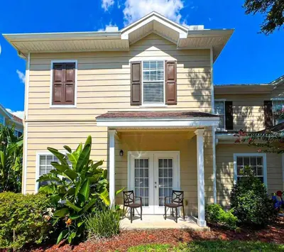 a house with two chairs in front of it at Perfect vacation spot near Disney 7105 in Kissimmee