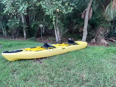 a yellow kayak sitting on the grass in a field at Home Away From Home in Kissimmee