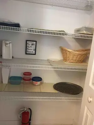 a kitchen shelf with bowls and baskets on it at Home Away From Home in Kissimmee