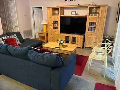 a living room with a blue couch and a tv at Home Away From Home in Kissimmee